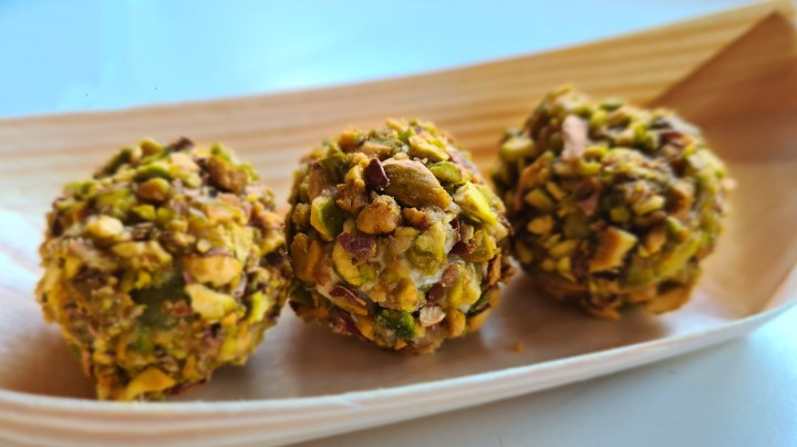 Acini di uva avvolti con salsa al gorgonzola e pralinati con pistacchio tostato.